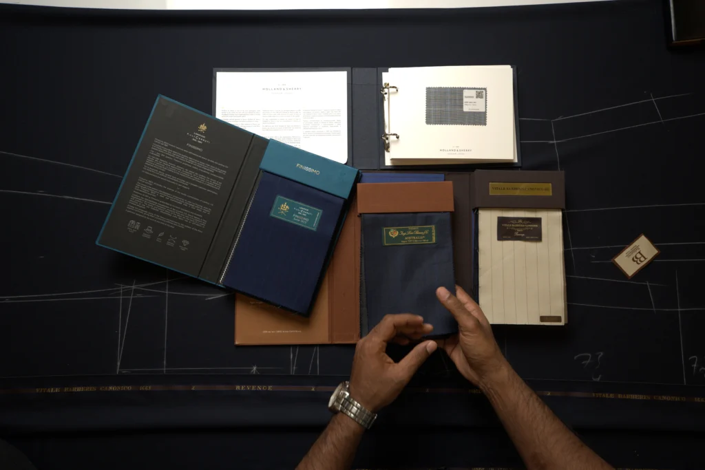 Belissimo Bespoke showroom displaying premium suit fabrics in refined colors and textures