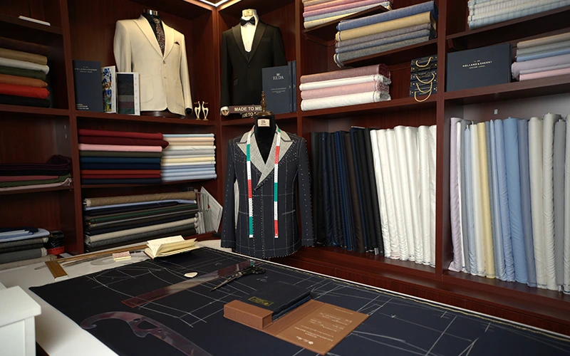 Interior of Belissimo showroom with shelves of suit fabrics in different colors and patterns